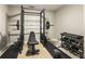 Basement home gym featuring a full weight rack and dumbbells at 832 Forest Path Ln, Alpharetta, GA 30022