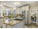 Gourmet kitchen with granite countertops, stainless steel appliances, and views into the dining room at 832 Forest Path Ln, Alpharetta, GA 30022