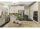 Spacious kitchen with granite island, stainless appliances, custom cabinets, and double ovens at 832 Forest Path Ln, Alpharetta, GA 30022