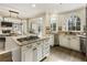 Open kitchen with granite island, stainless appliances, custom cabinetry, and view to the living room at 832 Forest Path Ln, Alpharetta, GA 30022