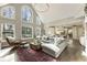 Spacious living room with a fireplace, large windows and view of the kitchen at 832 Forest Path Ln, Alpharetta, GA 30022