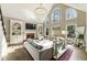 Bright living room with large windows, vaulted ceilings, fireplace, and hardwood floors at 832 Forest Path Ln, Alpharetta, GA 30022