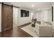 Spacious living room with sliding barn door and a large screen television at 832 Forest Path Ln, Alpharetta, GA 30022