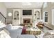 Cozy living room with a brick fireplace, built-in shelves, and hardwood floors at 832 Forest Path Ln, Alpharetta, GA 30022