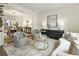 Bright living room with plush seating, stylish decor, and view to the dining room at 832 Forest Path Ln, Alpharetta, GA 30022