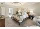 Bright main bedroom featuring tray ceilings, a large window, sitting area, and ensuite bathroom at 832 Forest Path Ln, Alpharetta, GA 30022