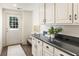 Well-lit mudroom features black granite countertops, custom cabinets, and convenient access to the outdoors at 832 Forest Path Ln, Alpharetta, GA 30022