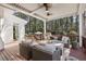 Relaxing outdoor patio features wicker furniture, a ceiling fan and access to the backyard at 832 Forest Path Ln, Alpharetta, GA 30022
