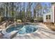 Backyard pool and jacuzzi with an umbrella-covered table and chairs at 832 Forest Path Ln, Alpharetta, GA 30022