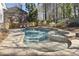 Backyard pool and jacuzzi area with a waterfall feature at 832 Forest Path Ln, Alpharetta, GA 30022