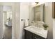 Stylish powder room features a marble countertop vanity and a mirror at 832 Forest Path Ln, Alpharetta, GA 30022