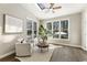 Inviting sunroom with vaulted ceiling, skylight, ceiling fan, and large windows for natural light at 832 Forest Path Ln, Alpharetta, GA 30022