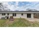 Backyard featuring a patio, a white brick house, and a dog house at 1385 Lucky Sw Ln, Mableton, GA 30126