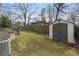 Spacious backyard with a storage shed and a tall wooden fence at 1385 Lucky Sw Ln, Mableton, GA 30126