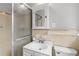 Bathroom featuring tiled walls, glass-enclosed shower, and a sink with storage at 1385 Lucky Sw Ln, Mableton, GA 30126