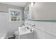 Bathroom featuring white tile, a window for light, a sink and vintage tile at 1385 Lucky Sw Ln, Mableton, GA 30126