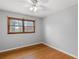 Cozy bedroom with hardwood floors, ceiling fan, and a window offering natural light at 1385 Lucky Sw Ln, Mableton, GA 30126