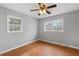 Bedroom showcasing hardwood floors, windows for natural light, and a ceiling fan at 1385 Lucky Sw Ln, Mableton, GA 30126