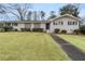 Charming single-story brick home with a well-manicured lawn and inviting walkway at 1385 Lucky Sw Ln, Mableton, GA 30126