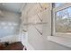 View of unfinished room with wire shelving unit and a window letting in natural light at 1385 Lucky Sw Ln, Mableton, GA 30126