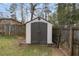 Close up of storage shed in backyard with double doors and a raised platform at 1385 Lucky Sw Ln, Mableton, GA 30126