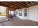 Covered back porch with wooden decking and seating area, perfect for relaxing outdoors at 2010 Skylar Leigh Dr, Buford, GA 30518
