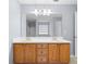 Bright bathroom featuring a double sink vanity with oak cabinets and a large mirror at 2010 Skylar Leigh Dr, Buford, GA 30518