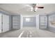 Large bedroom featuring soft carpeting, recessed lighting, built-in shelving, and natural light from large windows at 2010 Skylar Leigh Dr, Buford, GA 30518