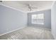 Bright bedroom featuring plush carpeting, a ceiling fan, and a window for ample natural light at 2010 Skylar Leigh Dr, Buford, GA 30518