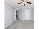 Large bedroom with soft carpeting, ceiling fan, two entry points, and white doors at 2010 Skylar Leigh Dr, Buford, GA 30518