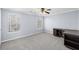 Carpeted bedroom boasts natural light, ceiling fan, and neutral gray walls at 2010 Skylar Leigh Dr, Buford, GA 30518