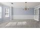 Formal dining room featuring wainscoting, chair rail, chandelier and plush carpet at 2010 Skylar Leigh Dr, Buford, GA 30518
