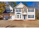 Charming two-story home features a two-car garage, beautiful stone accents and blue shutters at 2010 Skylar Leigh Dr, Buford, GA 30518
