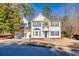 Charming two-story home features a two-car garage, beautiful stone accents and blue shutters at 2010 Skylar Leigh Dr, Buford, GA 30518