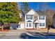 Charming two-story home features a two-car garage, beautiful stone accents and blue shutters at 2010 Skylar Leigh Dr, Buford, GA 30518