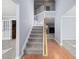Light-filled foyer boasts hardwood floors, a staircase with white railings and neutral paint at 2010 Skylar Leigh Dr, Buford, GA 30518