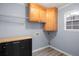 Compact laundry room with cabinets for storage, utility sink, and space-saving shelving at 2010 Skylar Leigh Dr, Buford, GA 30518