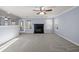 Bright living room with gray carpet, fireplace, ceiling fan, and natural light at 2010 Skylar Leigh Dr, Buford, GA 30518
