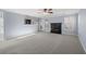 Open-concept living room with gray carpet, fireplace, and view of the kitchen at 2010 Skylar Leigh Dr, Buford, GA 30518