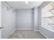Walk-in closet with window, soft carpeting, and wire shelving for organized storage at 2010 Skylar Leigh Dr, Buford, GA 30518