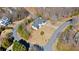 A high-angle shot features a suburban home with a lush, green yard, complemented by mature trees at 2949 Summitop Ne Ct, Marietta, GA 30066