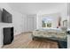 Bright bedroom features wood-look floors, large window, closet, and flat screen TV at 2949 Summitop Ne Ct, Marietta, GA 30066