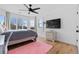 Bright bedroom features wood-look floors, a large window, a ceiling fan, and flat screen TV at 2949 Summitop Ne Ct, Marietta, GA 30066
