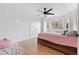 Cozy bedroom features wood-look floors, large window, a ceiling fan, and closet with doors at 2949 Summitop Ne Ct, Marietta, GA 30066