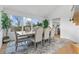 Bright dining room featuring a large window with backyard view, wood table and seating for six at 2949 Summitop Ne Ct, Marietta, GA 30066