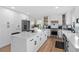 Modern kitchen featuring stainless steel appliances, white cabinets, and an island with marble countertops at 2949 Summitop Ne Ct, Marietta, GA 30066