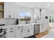 Modern kitchen featuring stainless steel appliances, white cabinets, and an island with marble countertops at 2949 Summitop Ne Ct, Marietta, GA 30066