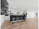 Modern basement kitchen area featuring a bar with seating, open shelving, and stainless steel refrigerator at 2949 Summitop Ne Ct, Marietta, GA 30066