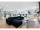 Bright living room featuring hardwood floors, a fireplace, modern furniture, and a partial view of the kitchen at 2949 Summitop Ne Ct, Marietta, GA 30066