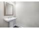 Cozy powder room featuring a pedestal sink, framed mirror, and wood-look flooring at 3533 Koyla Lndg # 5, Chamblee, GA 30341
